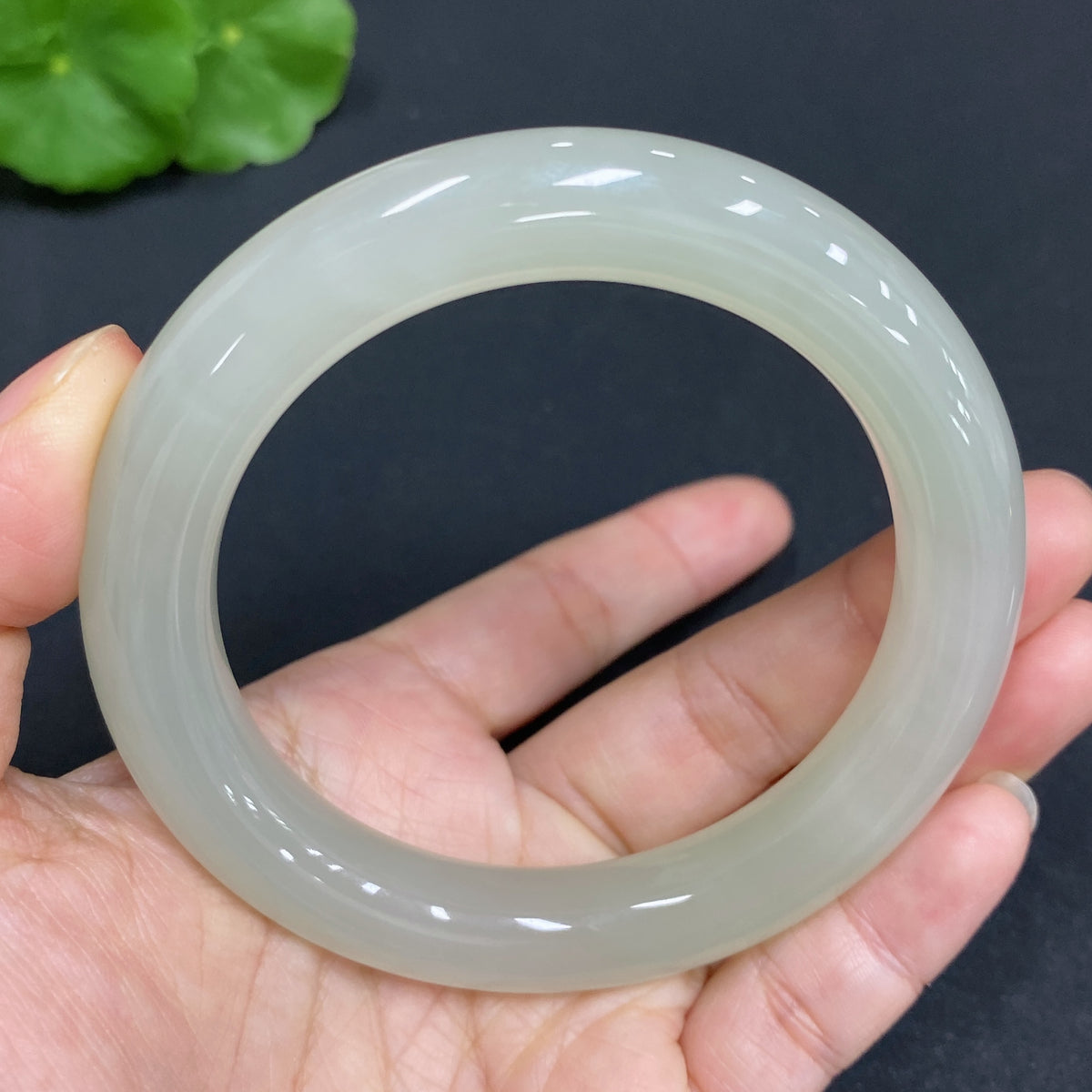 Huiliu Certified Hetian Jade Round Bracelet showcasing smooth, polished green jade beads on a delicate string.