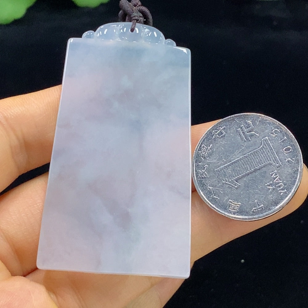 Antique jadeite pendant from HUILIU HQ featuring intricate carvings and a smooth, polished surface showcasing traditional jade craftsmanship.