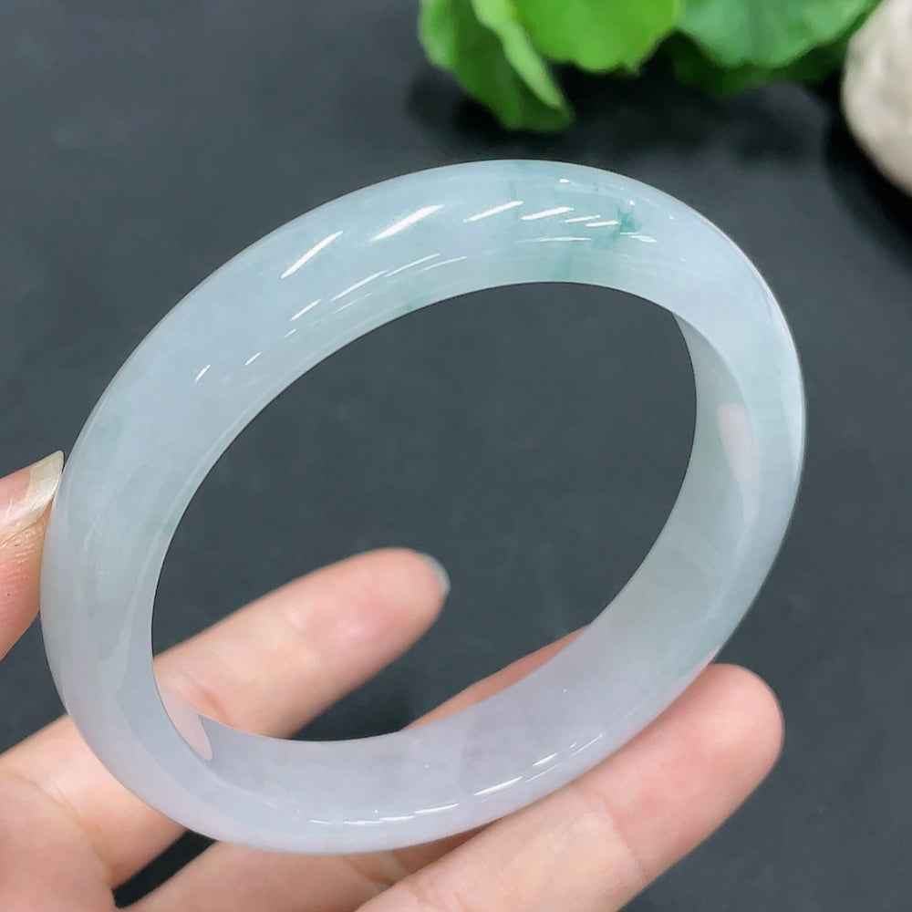 HUILIU HQ jadeite bangle in size 58.8mm, weighing 56.4g, showcasing smooth, polished green jade surface and rounded shape.