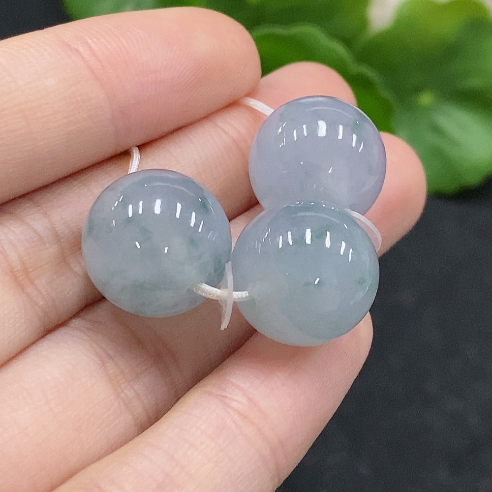 Huiliu Certified Jadeite beads lot showing smooth, polished green jade beads arranged together for jewelry making.