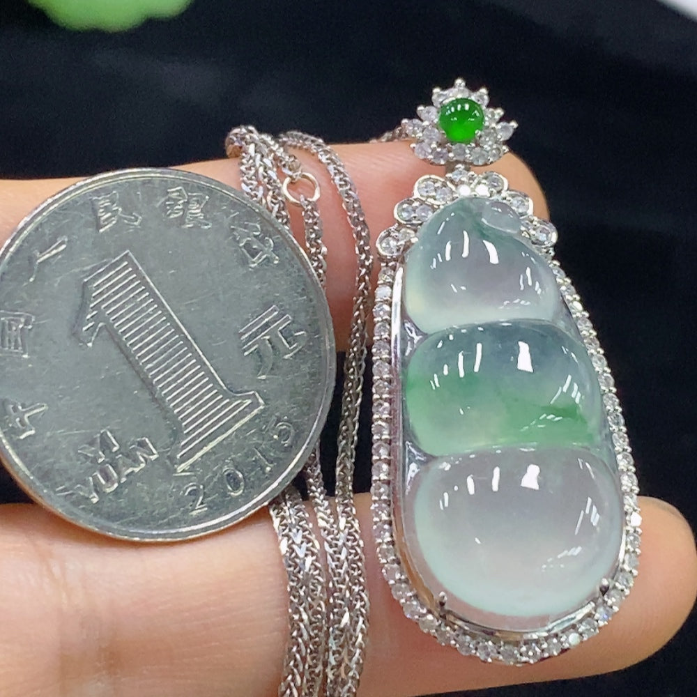 Jadeite bean inlay piece with 18K gold and diamond accents, including chain, by HUILIU HQ, weighing approximately 10.35g.