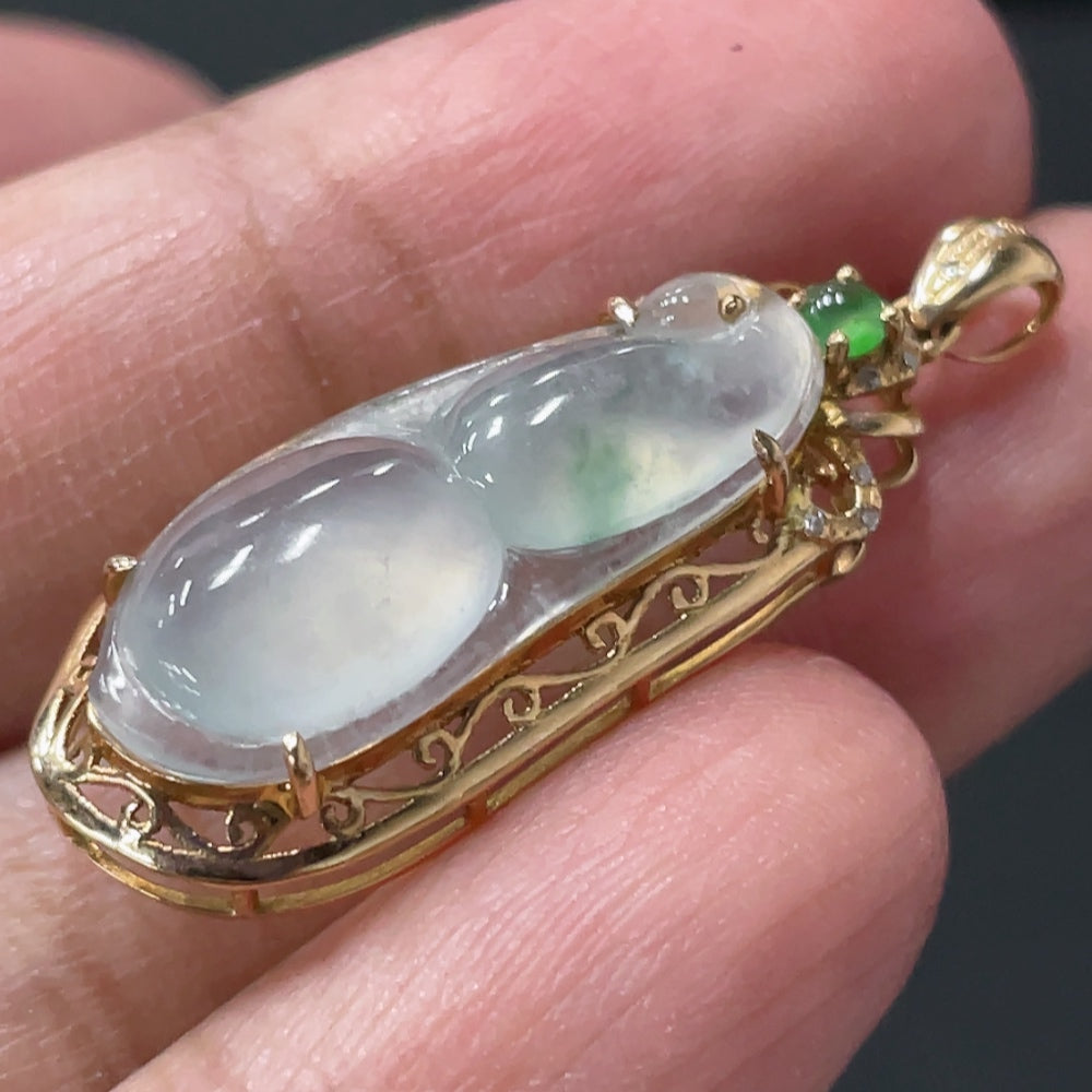 Jadeite blessed bean pendant by HUILIU HQ with 18K gold accents and diamond details, weighing approximately 2.46g.