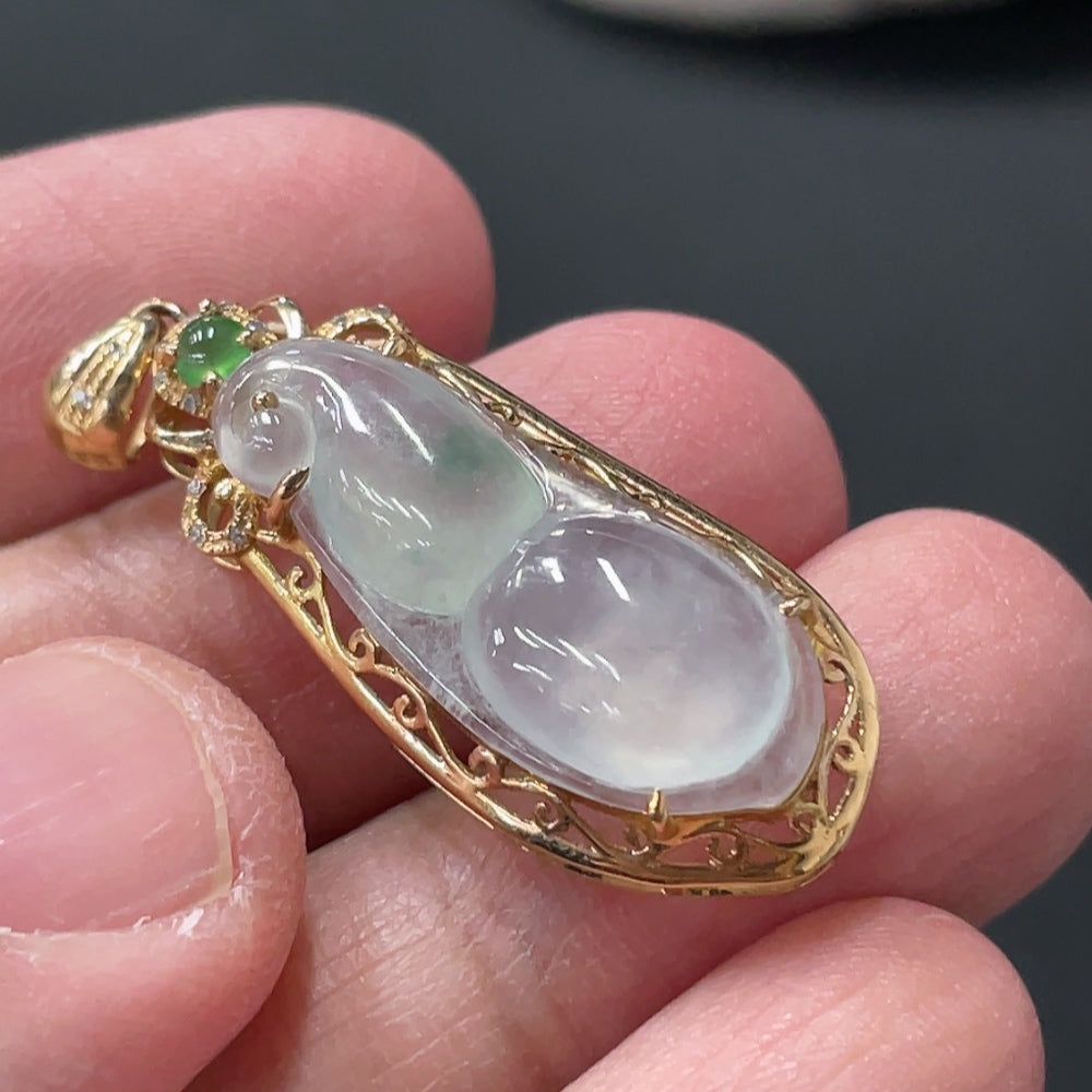 Jadeite blessed bean pendant with 18K gold accents and diamond details, crafted by HUILIU HQ, weighing approximately 2.46g.