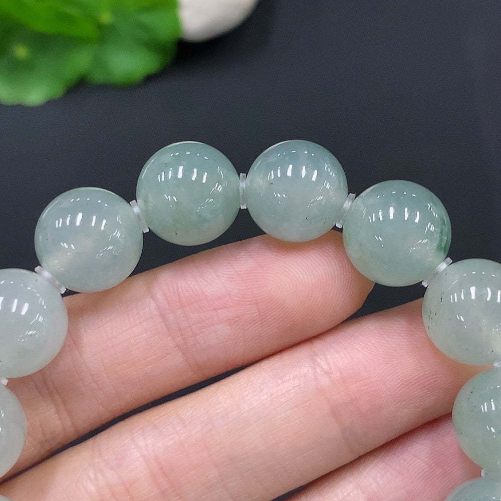 Huiliu HQ jadeite bracelet with 12.5mm beads, crafted from green jade, showcasing smooth, polished stones and a subtle natural sheen.