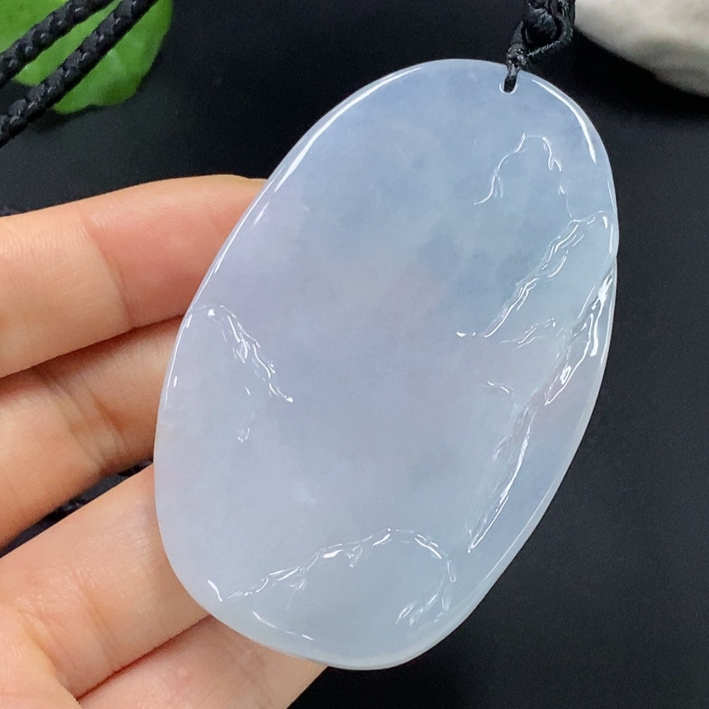 Jadeite Buddha observing the world pendant by HUILIU HQ, featuring a detailed carved jade Buddha figure in a natural setting.