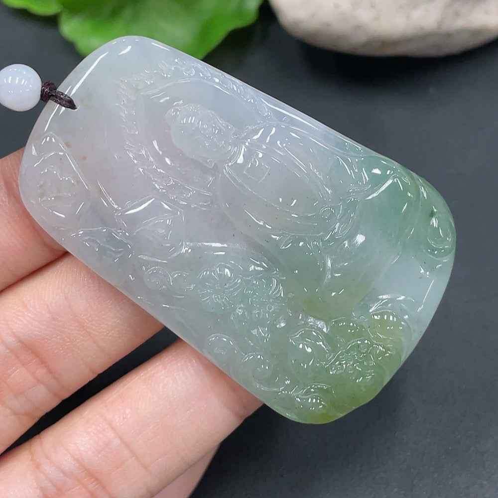 Jadeite Buddha pendant from HUILIU HQ, carved in green jade, weighs 28.657 grams, with detailed Buddha figure visible.