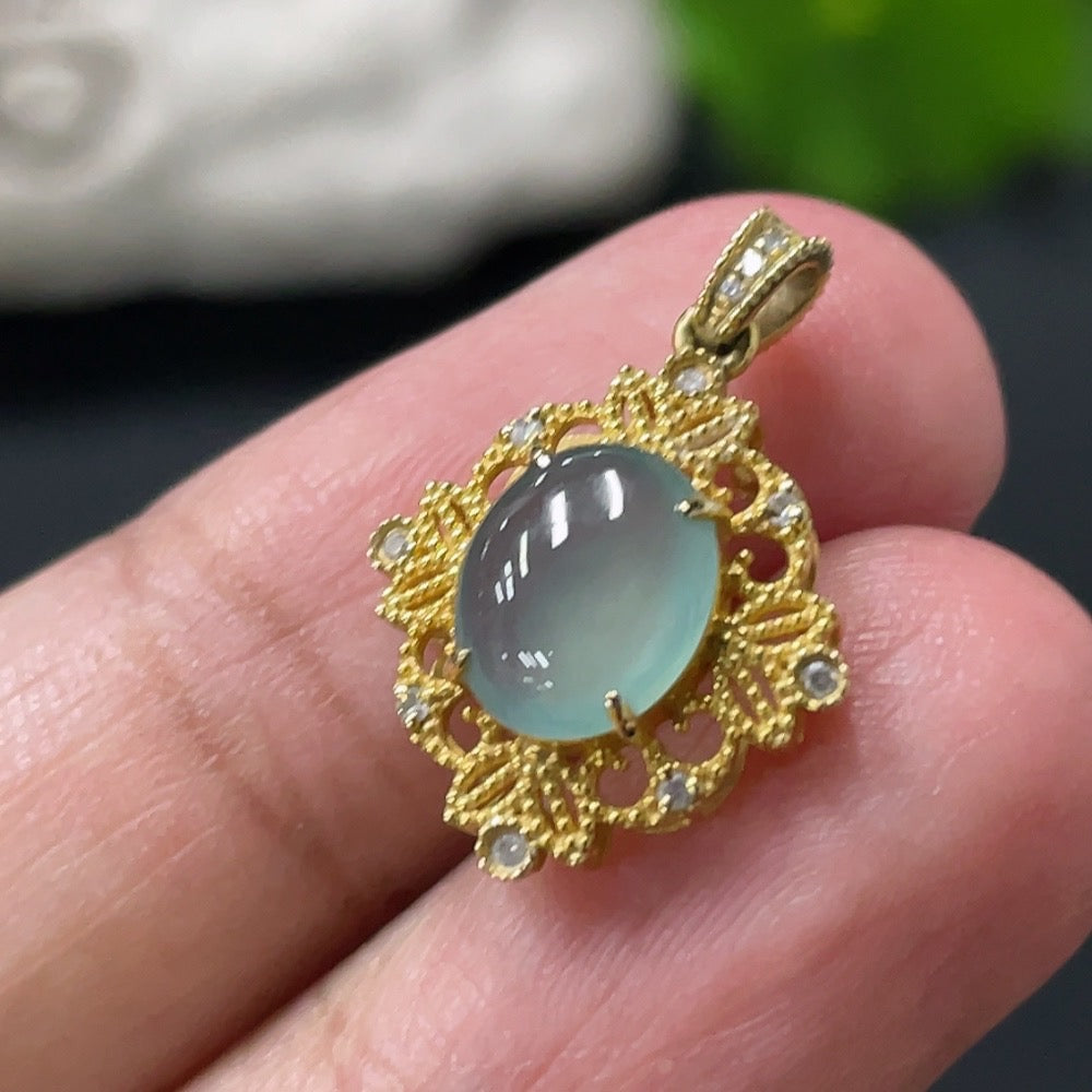 Jadeite cabochon pendant with 18K gold setting, showcasing a smooth, polished green jade stone on a delicate chain.