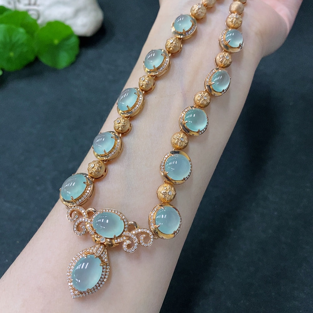 HUILIU HQ jadeite cabochon necklace with 18K gold and diamond accents, showcasing the elegant jewelry design.