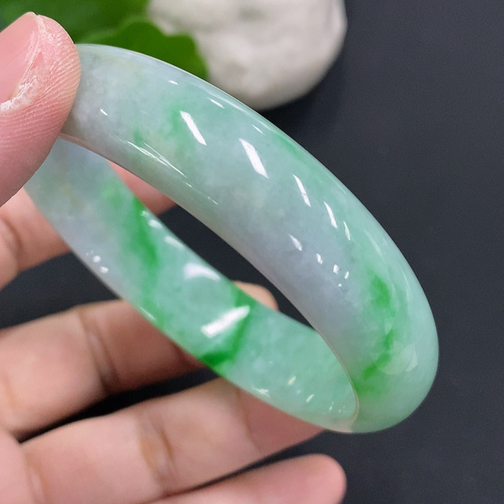 Broken jadeite concubine bracelet by HUILIU HQ, size 58/50.7, weight 49.1g, featuring green jade stones with visible damage.