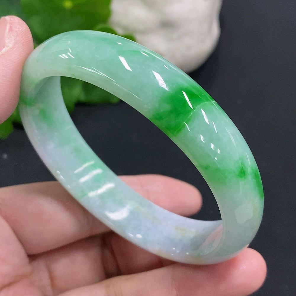 Damaged Jadeite Concubine Bracelet in size 58 from HUILIU HQ, showing broken section and detailed jade craftsmanship.