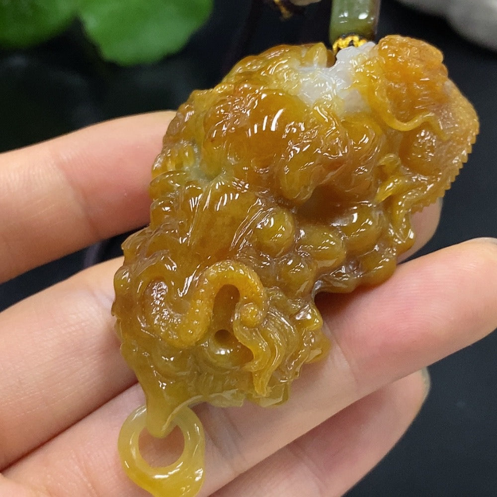 Jadeite dragon pendant from HUILIU HQ, 67.51g including rope, with undetermined color origin, featuring detailed dragon design.