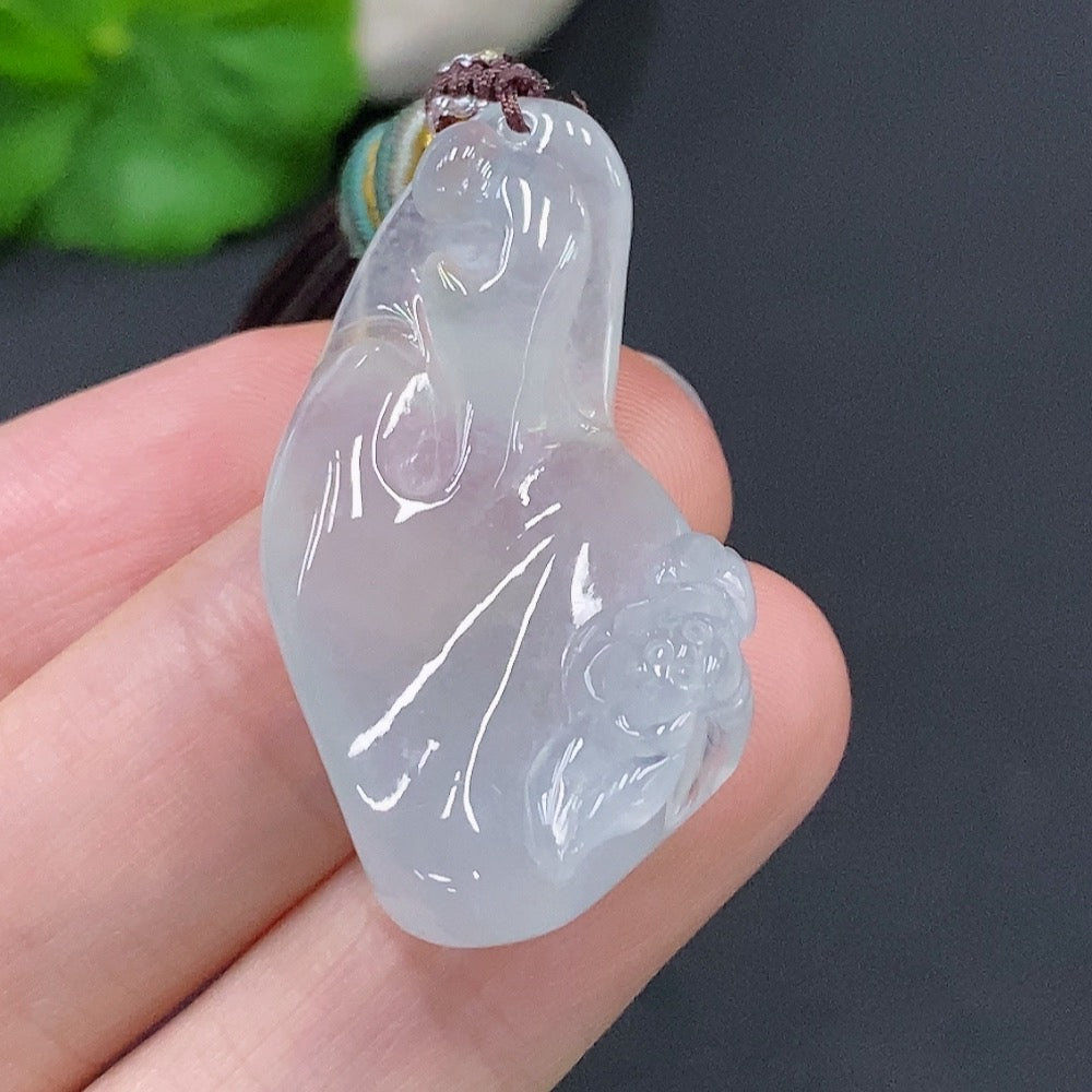 Jadeite Enlightenment Pendant by HUILIU HQ featuring a smooth, polished green jade pendant with intricate carvings.