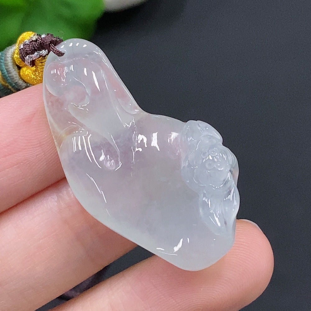 HUILIU HQ jadeite Enlightenment pendant featuring a smooth, polished green jade pendant with intricate carvings on a cord.