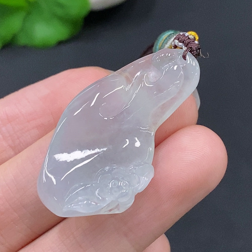 HUILIU HQ Jadeite Enlightenment Pendant featuring polished green jade with intricate carvings, hanging from a silk cord.