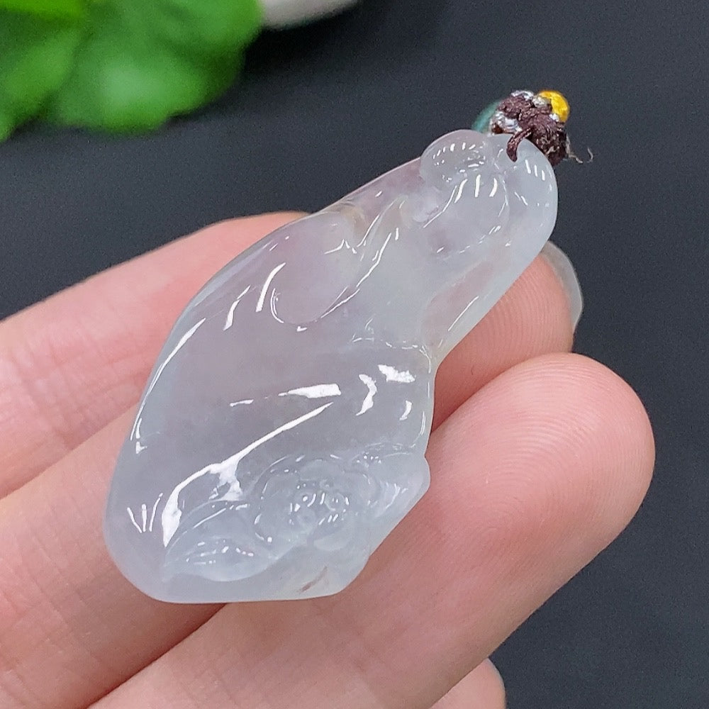HUILIU HQ jadeite Enlightenment pendant featuring a smooth, polished green jade stone with carved details, hanging from a silk cord.