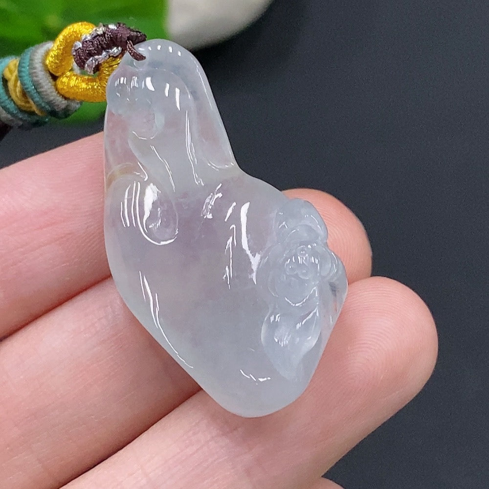 Handcrafted Jadeite Enlightenment Pendant by HUILIU HQ, showcasing smooth, polished jade with intricate carvings and vibrant green hues.