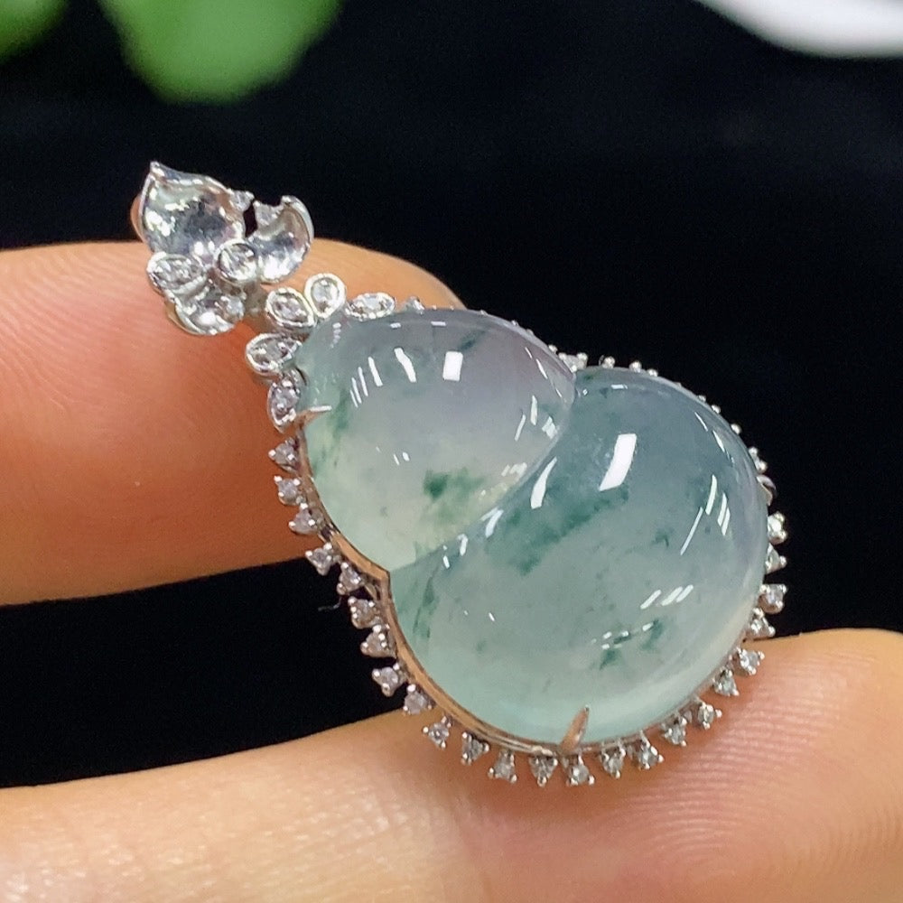 Jadeite gourd pendant with 18K gold and diamond inlays, showcasing intricate craftsmanship and a smooth, polished surface.