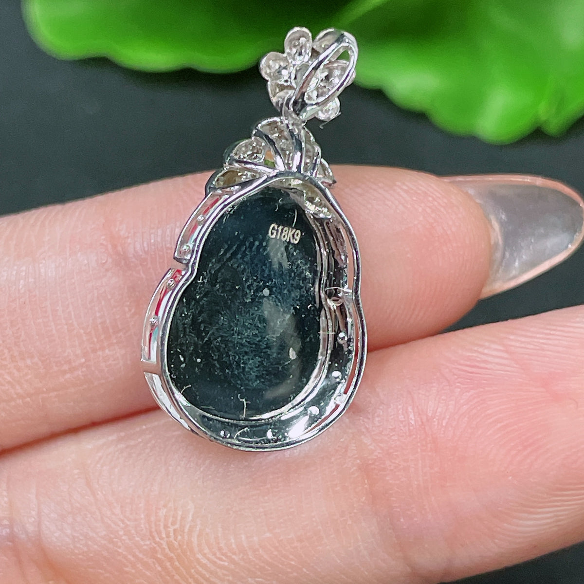 Jadeite gourd inlay piece set in 18k gold with diamond accents, colorless, from HUILIU HQ, weighing approximately 3.03g.