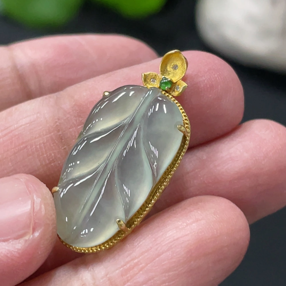 Jadeite leaf pendant with 18K gold inlay from HUILIU HQ, showcasing a delicate green jade leaf design with gold accents.