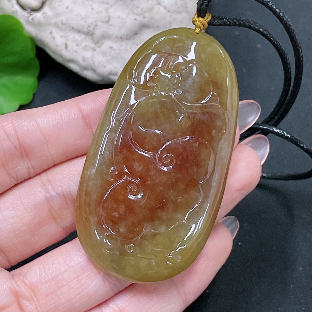 HUILIU HQ jadeite lotus pendant weighing approximately 36.65g with yellow-colored jade and attached rope.