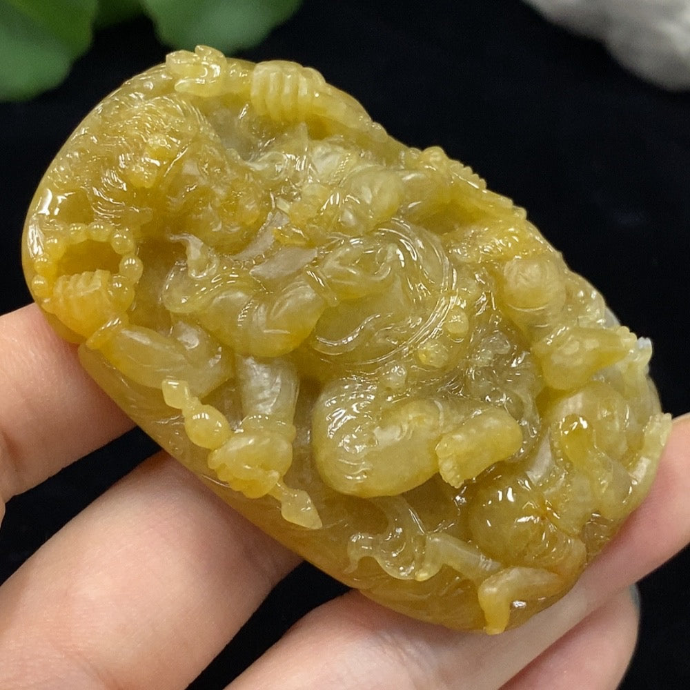 Jadeite Mahakala pendant from HUILIU HQ featuring a detailed carved design, weighs approximately 66.27g, with an undetermined color origin.