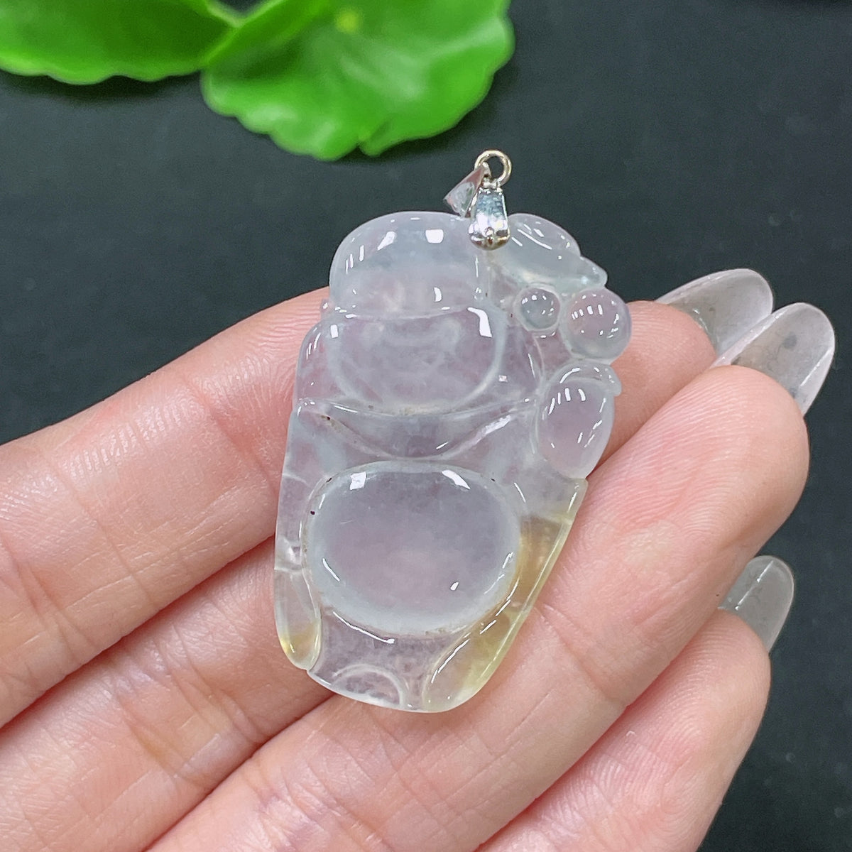Jadeite Buddha pendant with 18k bezel from HUILIU HQ, showcasing detailed jade carving and elegant design, weight approx. 8.08g.