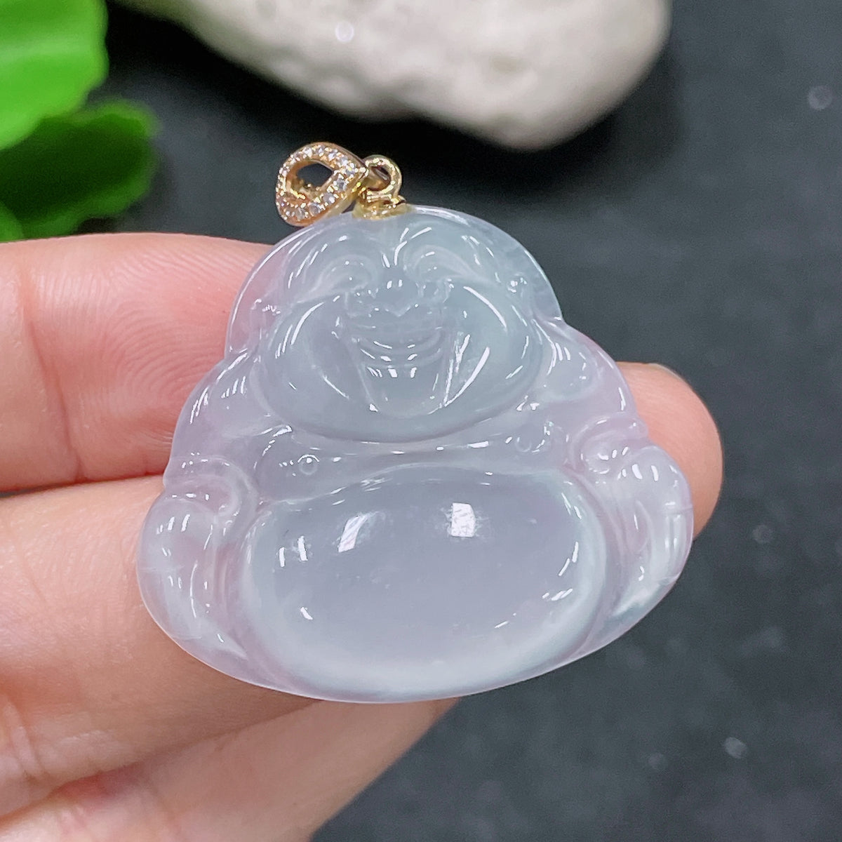 Jadeite pendant with Buddha design, 18K gold bail, diamond accents, by HUILIU HQ, weighing approximately 8 grams.