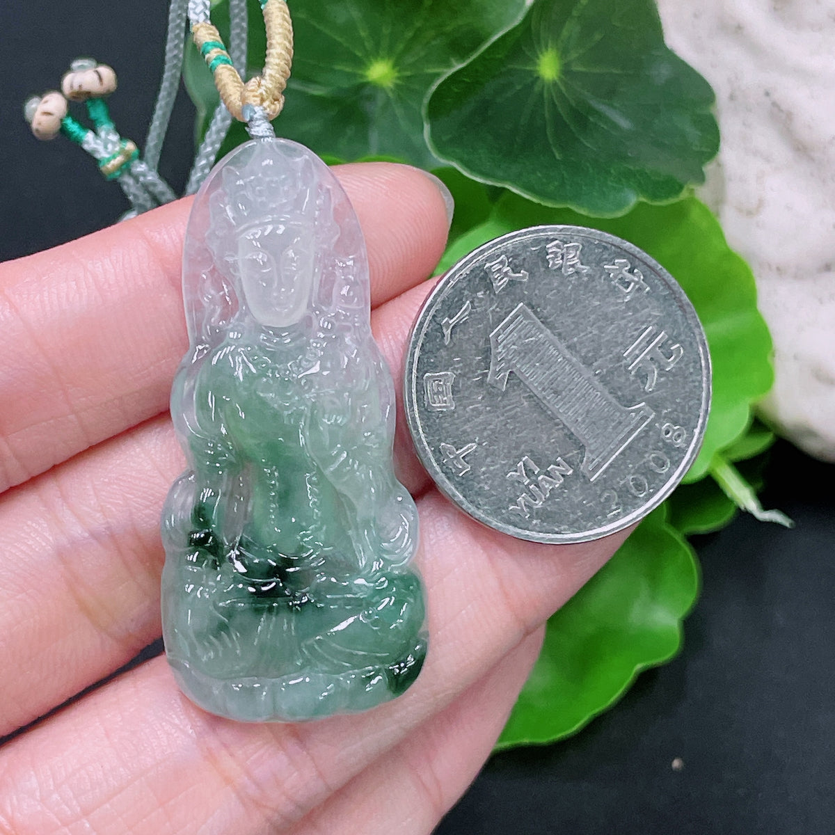 Huiliu Certified Jadeite Pendant Tara with rope, featuring smooth green jade and intricate carving, on a simple cord.