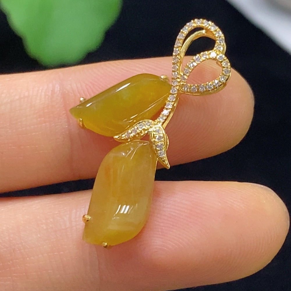 Jadeite pendant with 18k gold and diamond accents, featuring a smooth green jade stone and elegant design.
