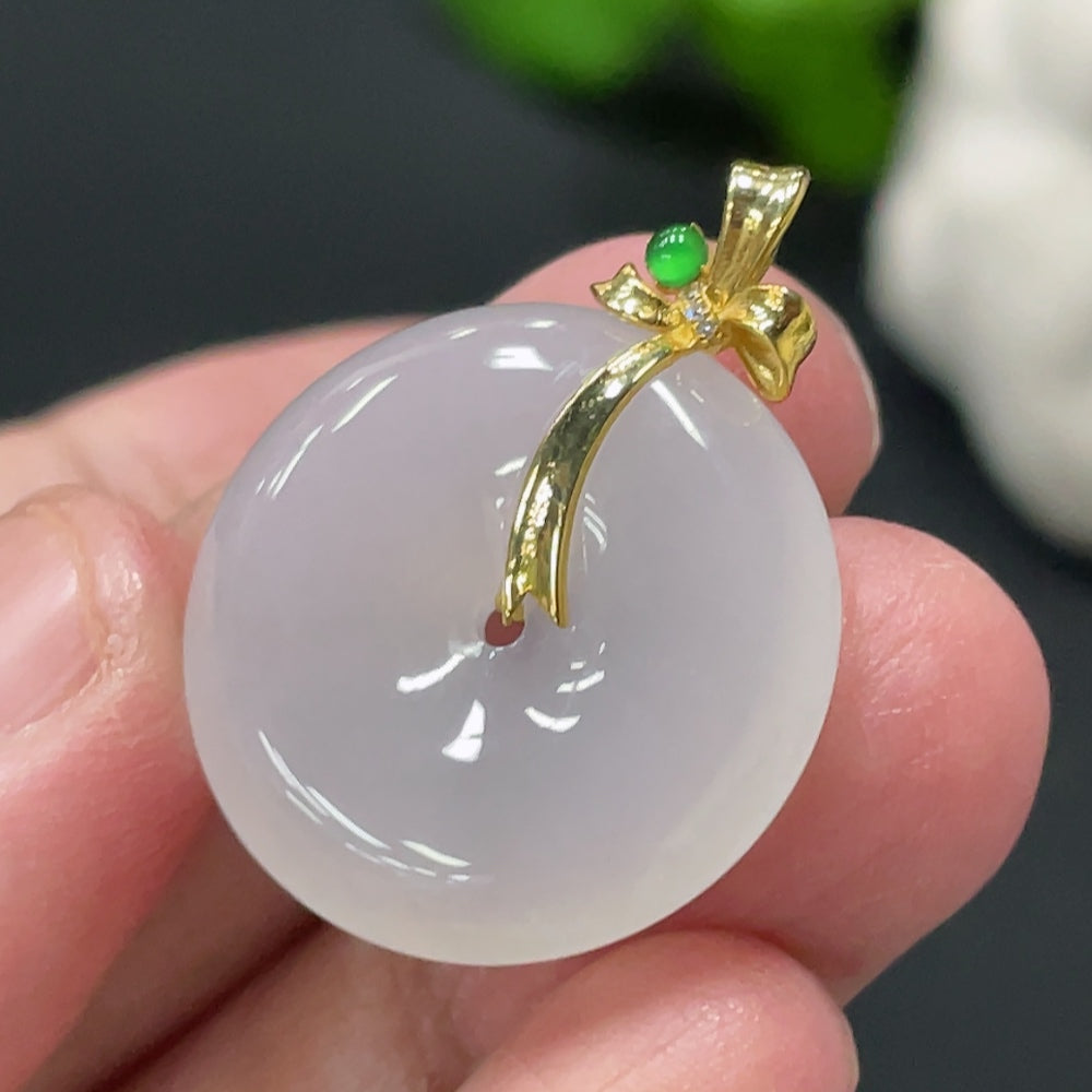 Jadeite pendant with peace knot design, 18K gold and diamond accents, weighing approximately 5.15g, from HUILIU HQ.