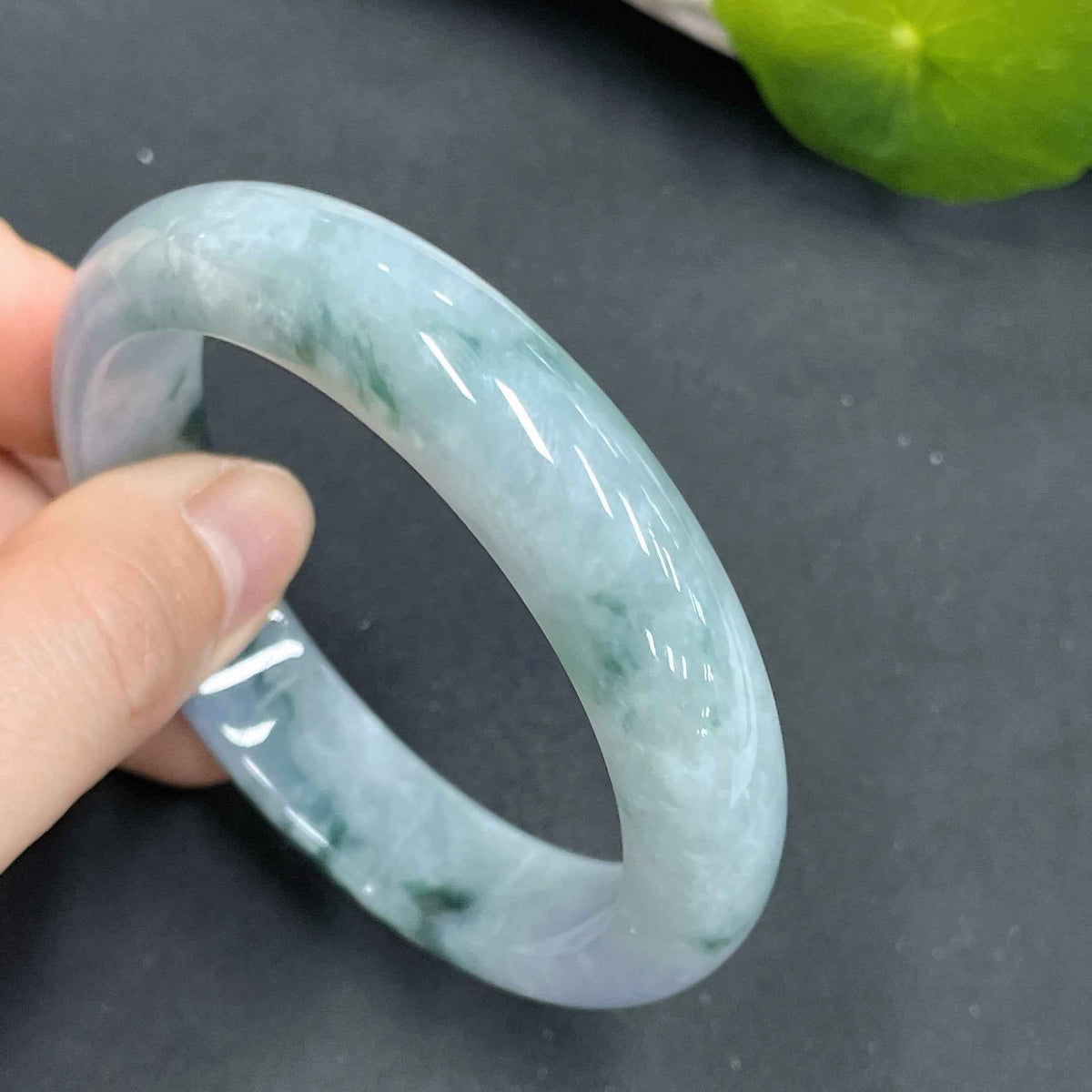 HUILIU HQ jadeite regular bangle with 53.8 cm circular size, smooth green jade jewelry bracelet on a plain background