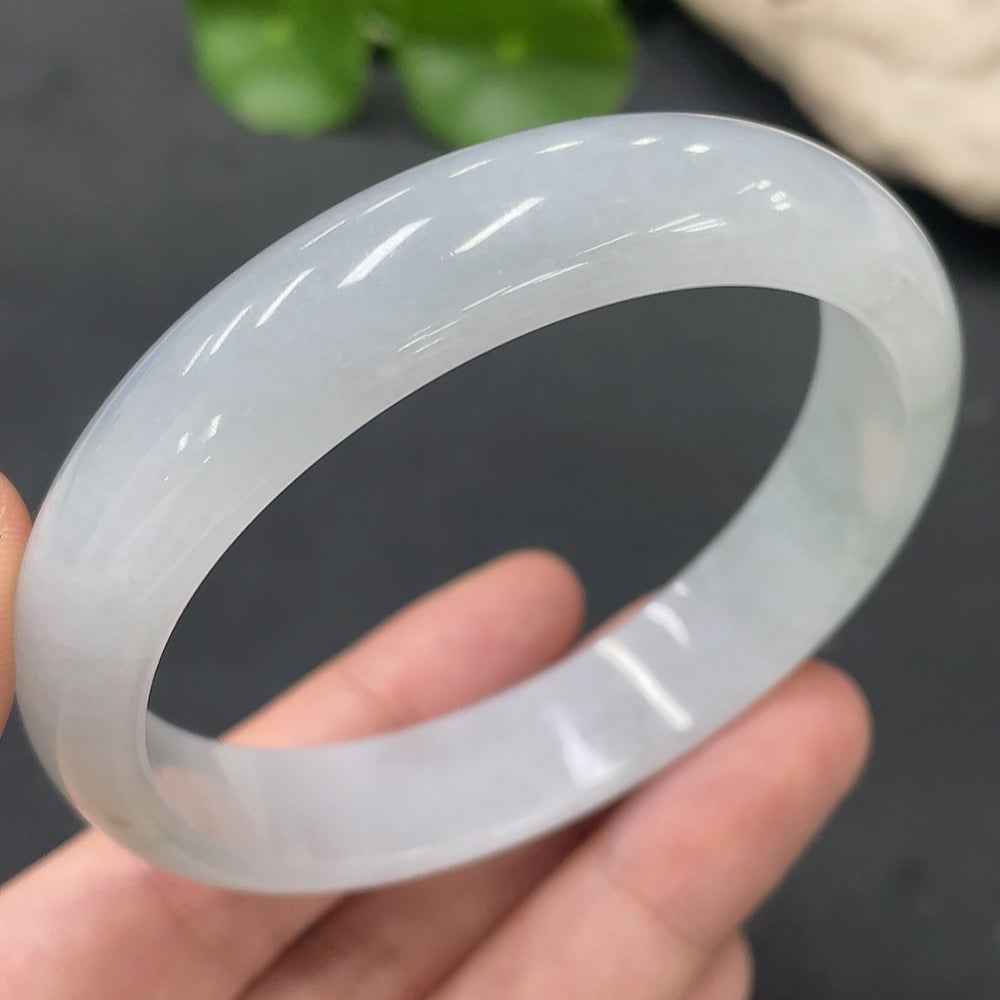 Huiliu HQ jadeite regular bangle made of polished green jade, showcasing a smooth, rounded design with natural jade coloration.