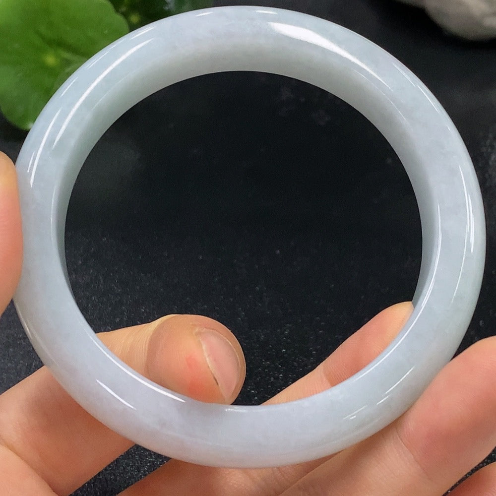 Huiliu HQ jadeite round bangle with smooth surface, natural green color, and Huiliu certified quality on a plain background.