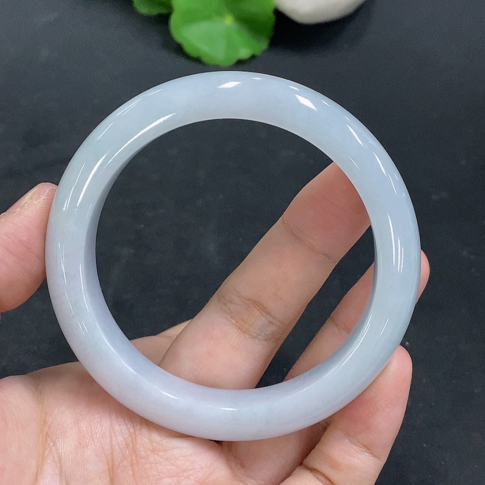 Huiliu Certified Jadeite Round Bangle showcasing smooth, polished green jade with a glossy finish on a plain background.