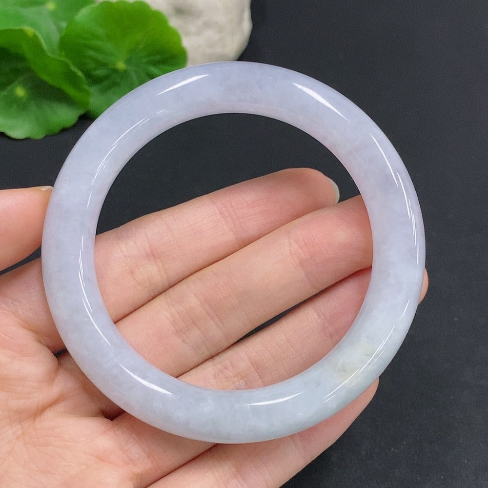 Huiliu Certified Jadeite Round Bangle featuring smooth, polished green jade with natural variations and a glossy finish.