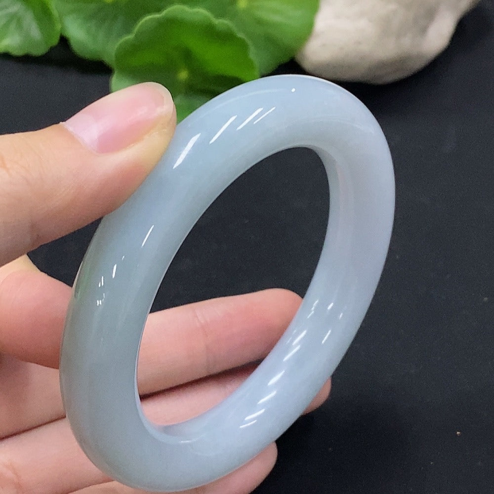 Huiliu Certified Jadeite round bangle showcasing smooth, polished jade with natural green and white hues.