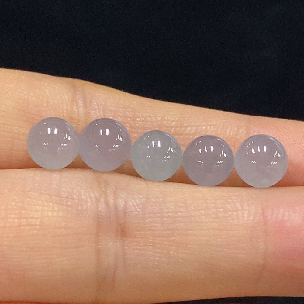 Huiliu Certified Jadeite round beads in a lot, showcasing smooth, polished green jade jewelry gemstones for crafting or collection.