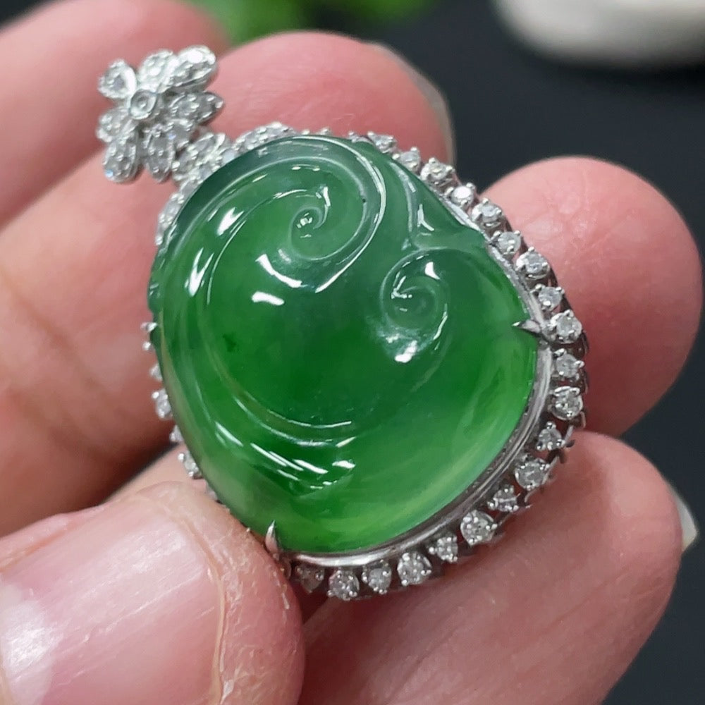 Jadeite Ruyi pendant with 18K gold and diamond accents, showcasing intricate inlay work and a polished jade surface.