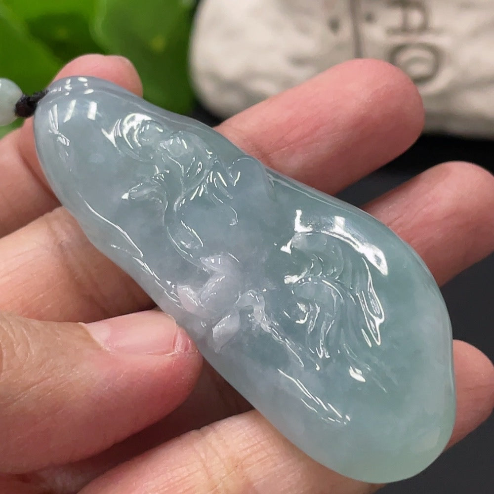 HUILIU HQ Jadeite Enlightenment Pendant featuring polished green jade stone with intricate carvings, hanging from a silk cord.