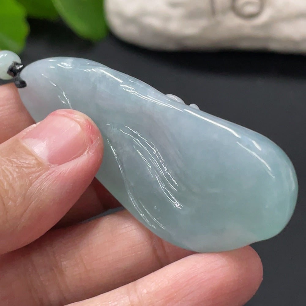 HUILIU HQ Jadeite Enlightenment Pendant featuring a polished green jade pendant with intricate carvings and smooth finish.