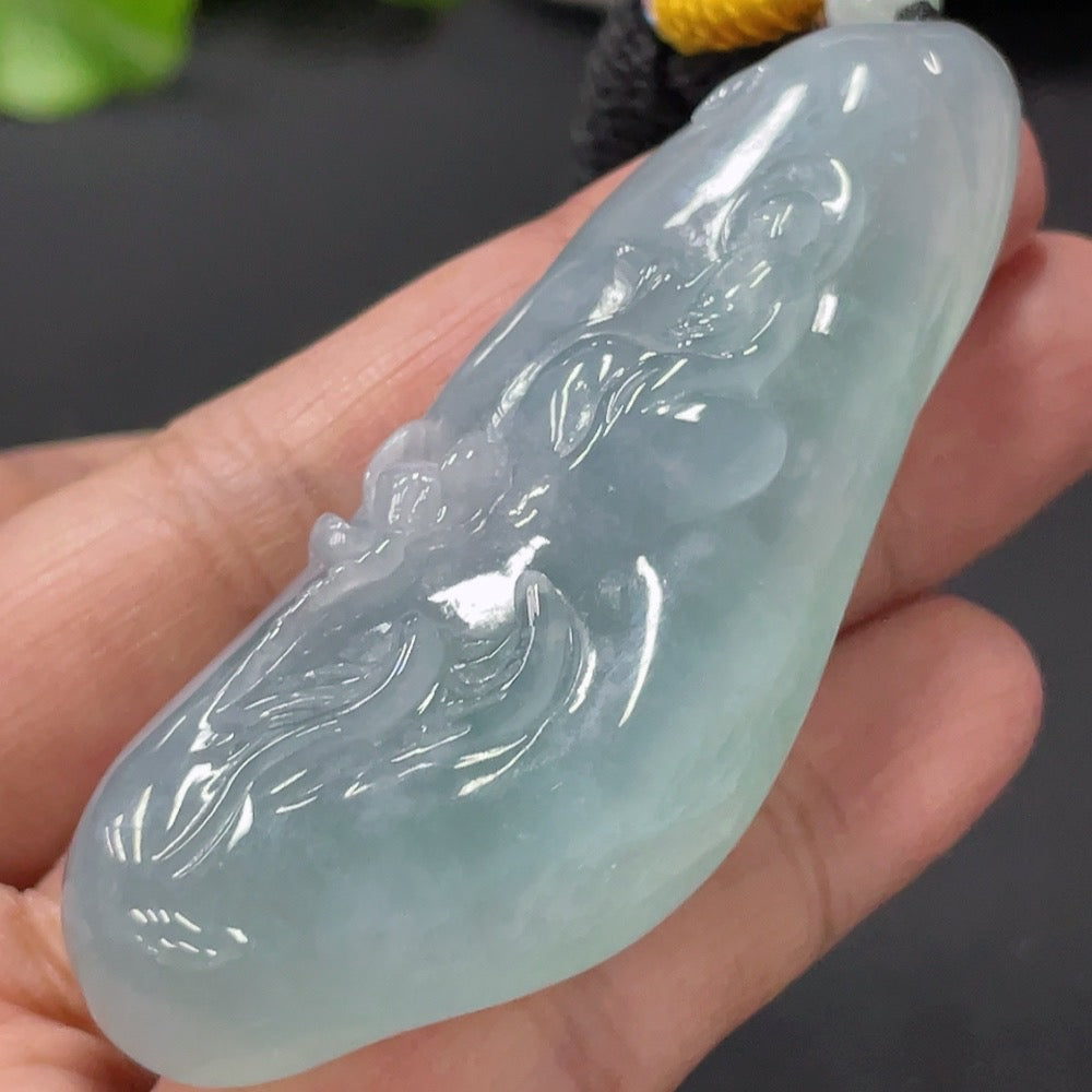 HUILIU HQ jadeite enlightenment pendant featuring a smooth, polished jade pendant with intricate carvings and natural green hue.