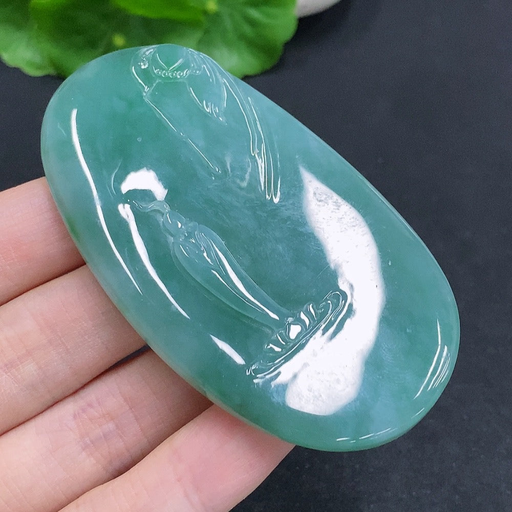 Jadeite Guanyin pendant with a formless design, crafted from green jade, showcasing intricate carvings and smooth polished surface.