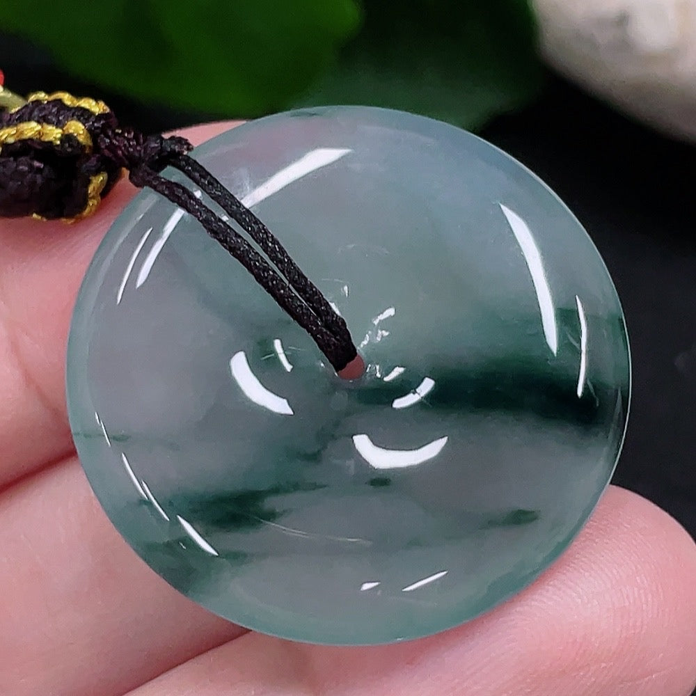 JadeitePeace buckle pendant made of green jade, featuring a smooth, polished surface and intricate carved design by HUILIU HQ.