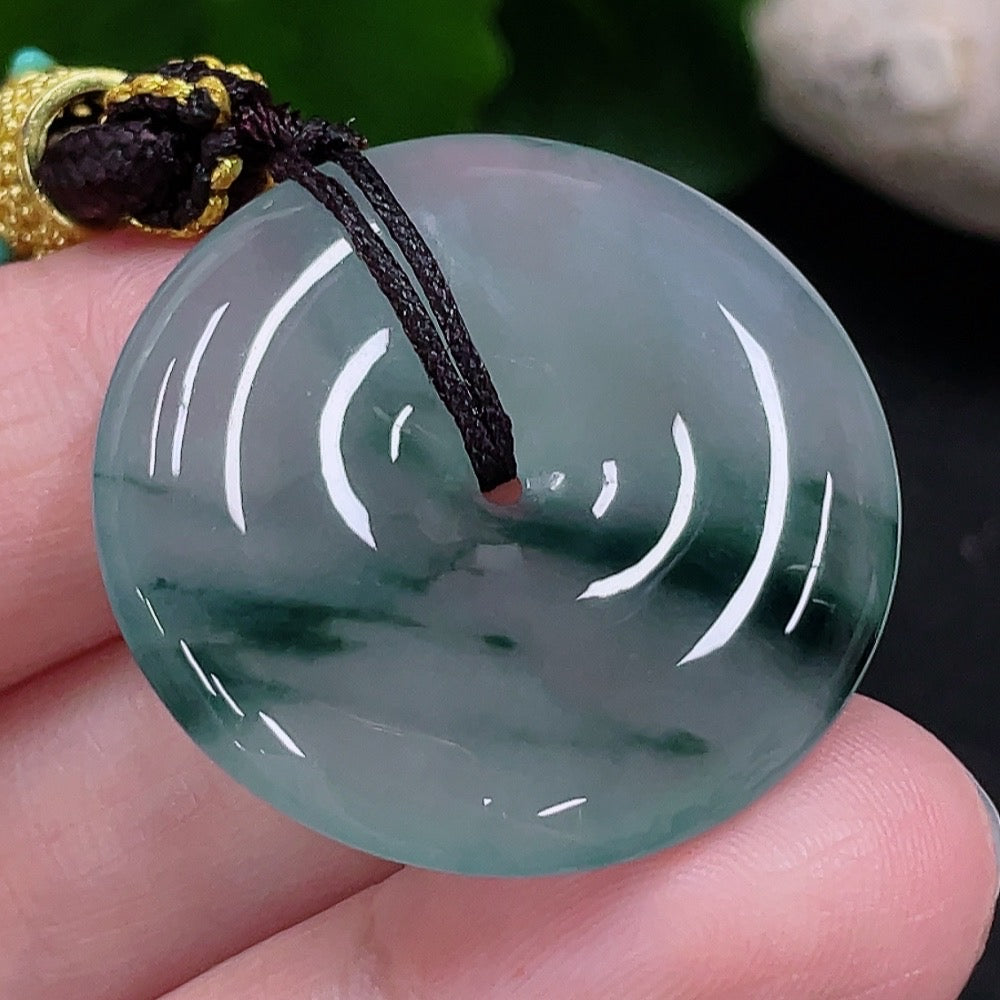 HUILIU HQ Jadeite Peace Buckle Pendant showcasing smooth, polished green jade with intricate carved design.