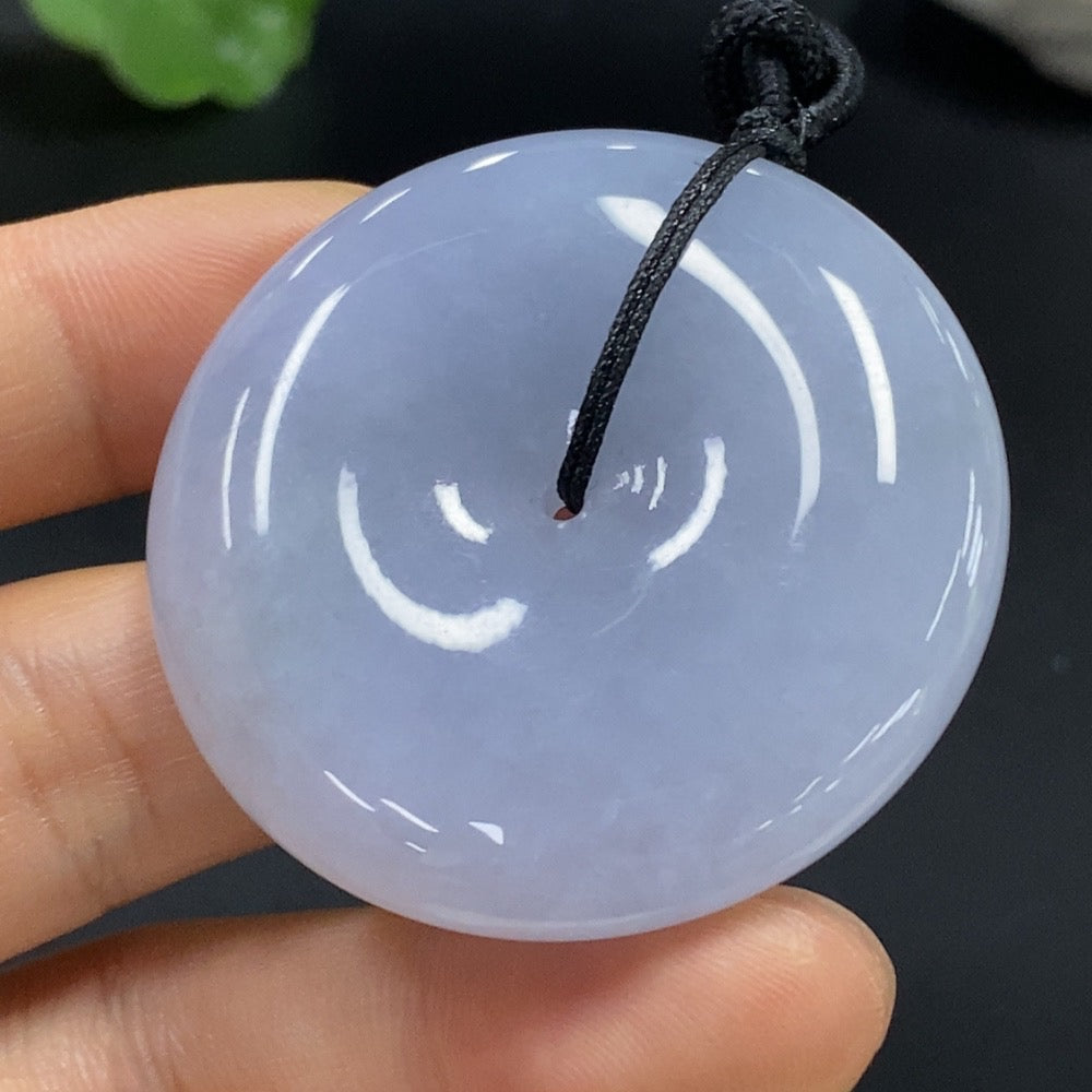 Natural jadeite Peace Knot pendant with intricate design, crafted by HUILIU HQ, showcasing smooth, polished jade in a close-up image.