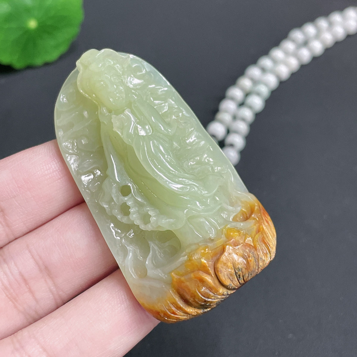 Huiliu certified Khotan jade Guanyin pendant with chain, featuring smooth green jade carving of Guanyin deity on a neutral background.