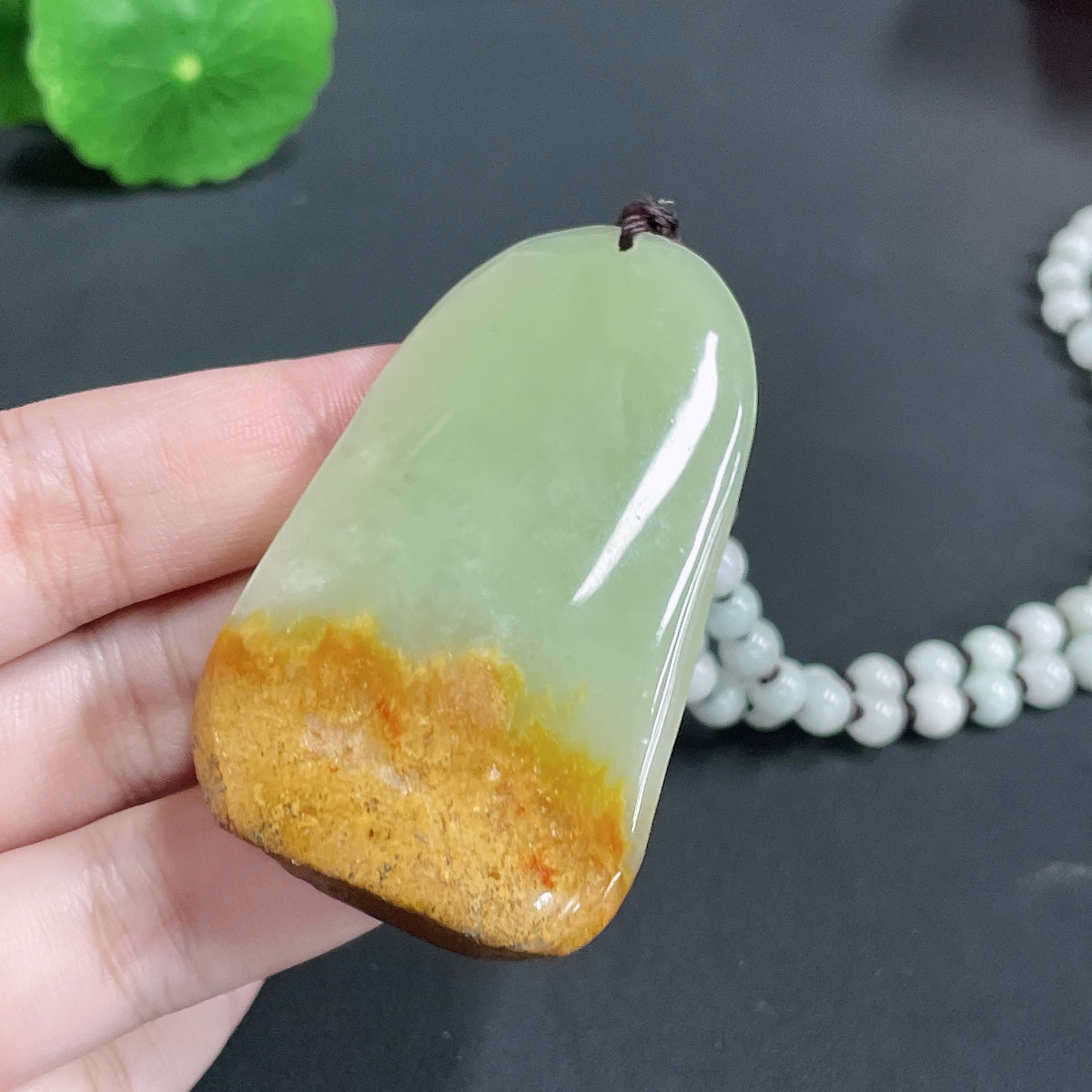 Huiliu certified Khotan jade pendant featuring Guanyin figure on a chain, with an undetermined skin tone, traditional craftsmanship.