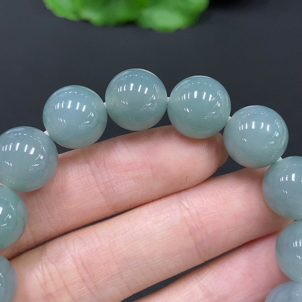 Huiliu Natural Grade A Jadeite bead bracelet with 12mm beads, weighing about 49.8g, featuring polished jade stones on a durable string.