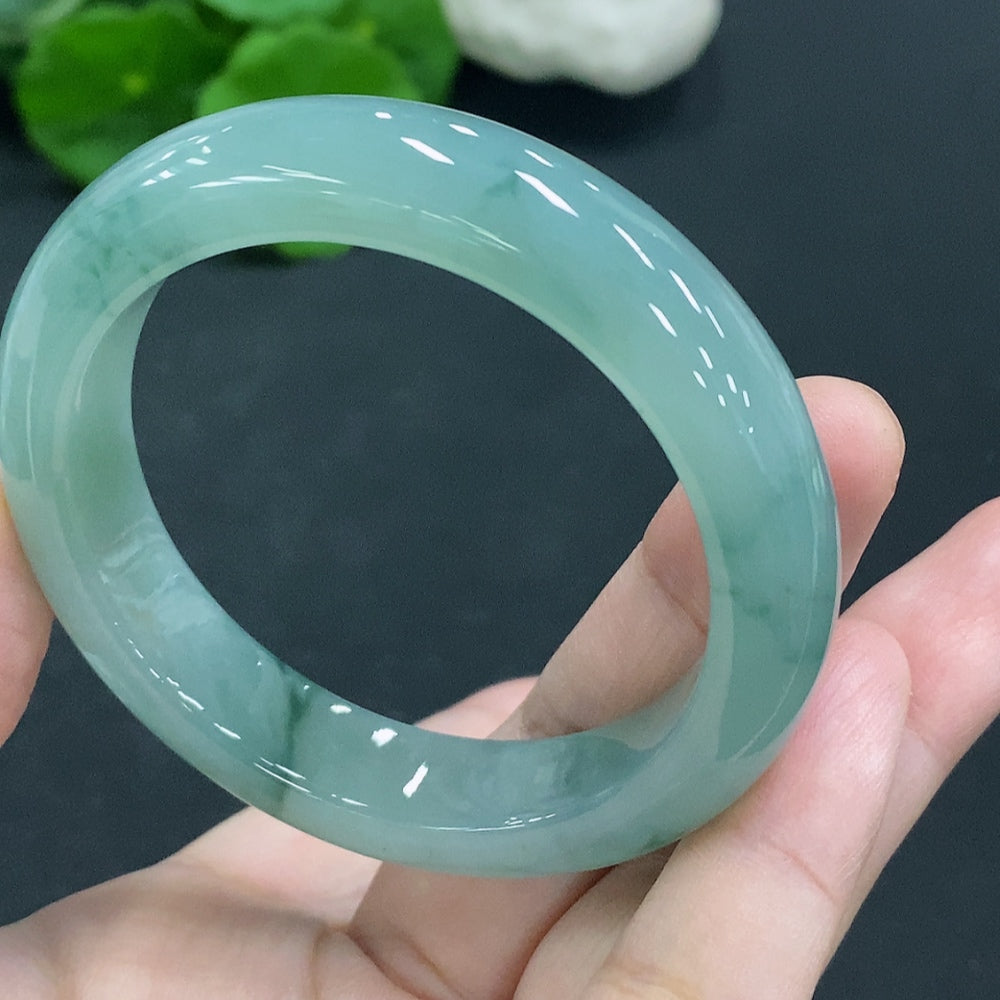 Natural Grade A Jadeite round bangle from HUILIU HQ, size 50.8, with a smooth polished surface and vibrant green color.