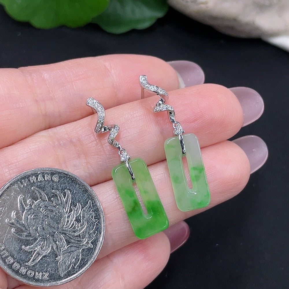 Pair of Jadeite earrings with 18K gold and diamond accents, showcasing smooth green jade stones and elegant gold setting.